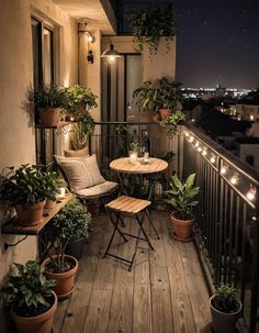 a balcony with potted plants and lights on the balconies is lit up at night