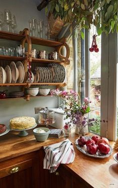 a kitchen counter topped with plates and bowls filled with food