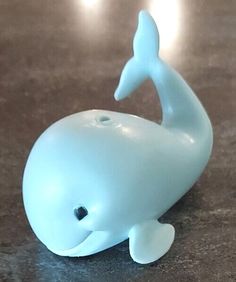 a blue whale toy sitting on top of a table