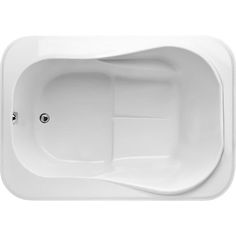 the bathtub is white and has an oval shaped tub with nozzles on it