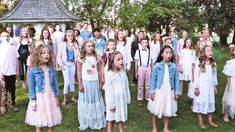 a group of young children standing next to each other in front of a gazebo