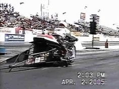 a motorcyclist is going down the track in front of an audience