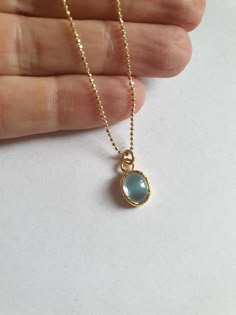 This minimalist Blue Topaz solid gold necklace was designed with a light blue December birthstone pendant, to beautifully accompany you through your busy days.The classic simple design is always pretty for day and evening, work or fun.The gold Blue Topaz necklace is handmade and delicate and available both with a 9kt or 14 karat pendant. The gold chain is made of 14k and available in a couple lengths.The clear Blue topaz necklace is a great birthstone necklace and a perfect chic and elegant gift Blue Topaz Birthstone Necklace With Oval Pendant, Blue Topaz Oval Pendant Necklace With Birthstone, Blue Topaz Oval Pendant Necklace As Gift, Blue Topaz Oval Pendant Necklace For Gift, Minimalist Gold Birthstone Necklace With Gemstone, Blue Dainty Birthstone Necklace For Anniversary, Minimalist Blue Birthstone Necklace, Blue Topaz Round Pendant Necklace Gift, Gift Blue Topaz Round Pendant Necklace