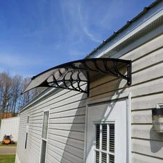 an awning on the side of a white house