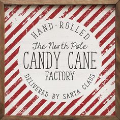 a sign that says, hand - rolled the north pole candy cane factory delivered by santa claus