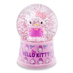 a pink hello kitty snow globe with glitter and bows on the top, in front of a white background