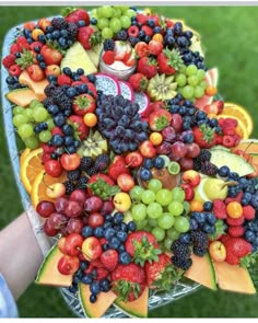 a platter filled with lots of different types of fruit