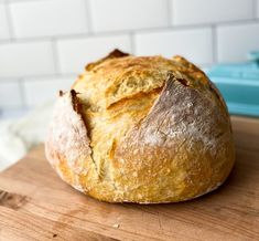 a loaf of bread sitting on top of a wooden cutting board