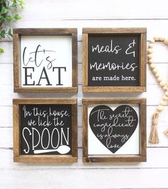 three framed signs with different sayings are displayed on a white wooden wall next to a plant