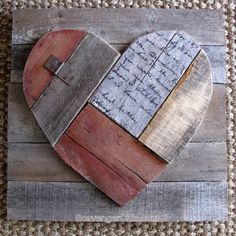 a heart made out of wooden planks with a cross on the top and words written in it