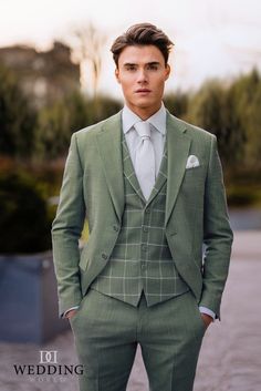 a man in a green suit and tie