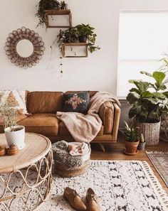 a living room filled with furniture and potted plants