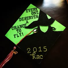 a green and black graduation cap that says every deserves a chance to fly