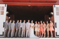 a group of people standing next to each other in front of a white barn door