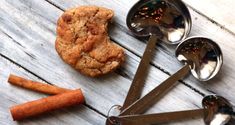 some spoons and cookies on a wooden table