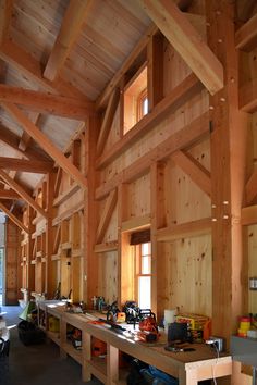 the inside of a building with wooden beams