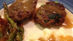 meatloaf with gravy, mashed potatoes and green beans on a plate