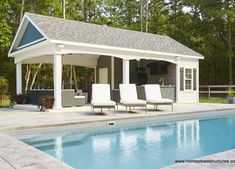 a pool house with lounge chairs next to it