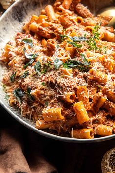 a bowl filled with pasta and meat on top of a table