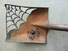 a spider web on the side of a wall with a hammer in it's hand