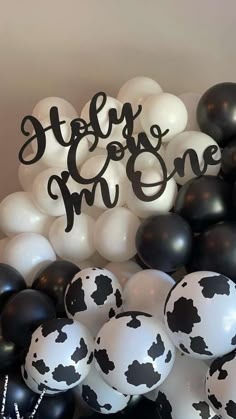 black and white balloons with the words marry me one on them are in front of a cake