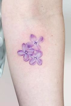 a small purple flower tattoo on the right thigh