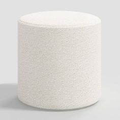 a white round stool on a grey background