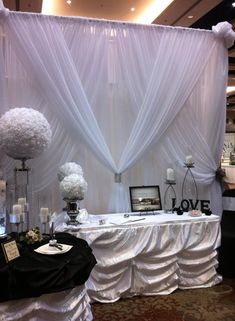 the table is set up with white flowers and candles