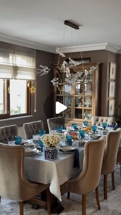 the dining room table is set with blue and white dishes