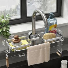 a kitchen sink with two drying racks holding towels and soaps