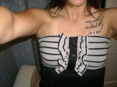 a woman wearing a black and white top with writing on her chest is posing for the camera