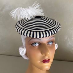 This Truly Delightful Toque Is Made Of Circles Of White And Navy Straw. The Edge Is Made Of Alternating Strips Of The Same Navy/White Straw. At The Center Of The Circle There Is A Navy Fabric Button. To Secure The Hat In A Tilted Position There Is A White Elastic Attached To The Inside. A Toque Is Small Cap Or Bonnet Having A Narrow Brim Or No Brim At All. Toques Were Popular From The 13th To The 16th Century In Europe, Especially France. The Mode Was Revived In The 1930s. There Is No Label, Indicating It Was A Custom-Made Creation. This Is An Authentic Piece Of Fashion History! This Hat Is In Wonderful Vintage Condition & Has Been Lovingly Preserved Among Over 1300 Vintage Hats We Have C Ostrich Feather Hat, Feather Hat, Navy Fabric, Colorful Feathers, Ostrich Feathers, Hats Vintage, Fashion History, Navy And White, Straw