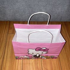 a hello kitty shopping bag sitting on the floor