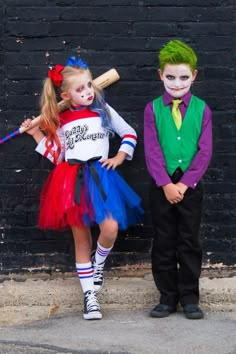 two children dressed up in costumes standing next to each other