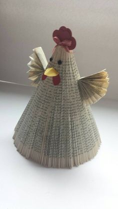 an origami chicken with a red hat on it's head and tail