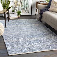 a living room with a couch, chair and rug