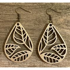 the earrings are made out of wood and have leaves on them