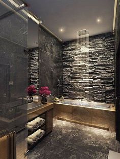 a bathroom with stone walls and a large tub