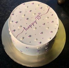 a birthday cake with white frosting and pink sprinkles on the top