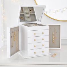 an open jewelry box on a white table