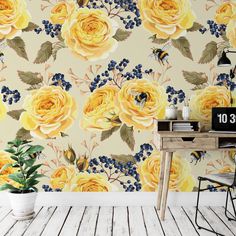 yellow roses and blue berries on a wallpaper mural in a room with a wooden table