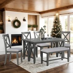 a dining room table and chairs with a fireplace in the background