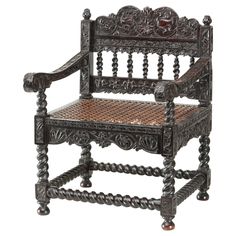 an old wooden chair with intricate carvings on the arm and back, sitting against a white background