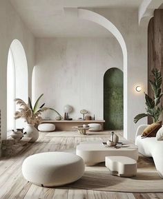 a living room filled with white furniture and lots of plants in the middle of it