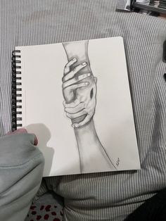 a drawing of a person's hand holding the wrist of another person with their arm wrapped around each other