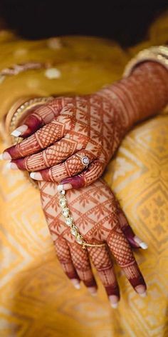 a woman's hands with hennap and jewelry