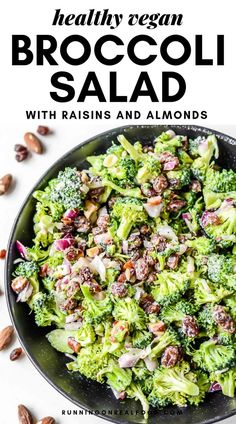 broccoli salad with raisins and almonds in a black bowl on a white background