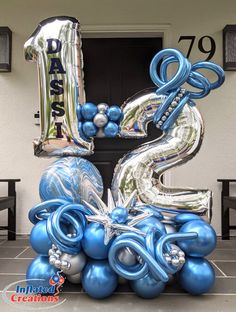 the number twenty five balloons are stacked on top of each other in blue and silver