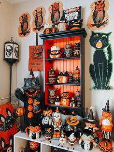 a room filled with lots of halloween decorations and pumpkins on the shelves in front of it