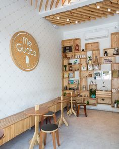 the interior of a restaurant with wooden tables and chairs